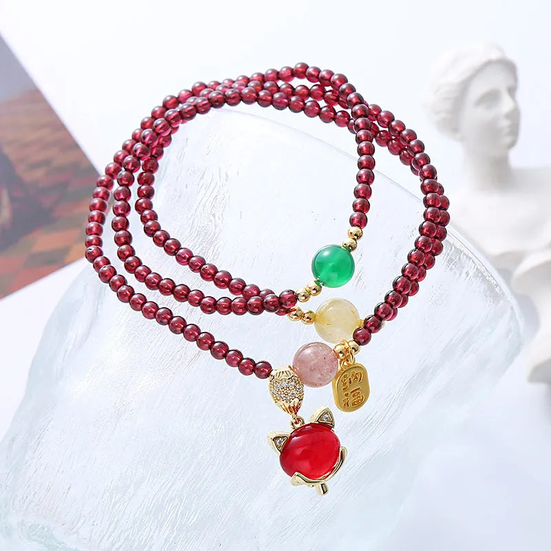 Purplish red garnet crystal bracelet with fox charm and adjustable rope