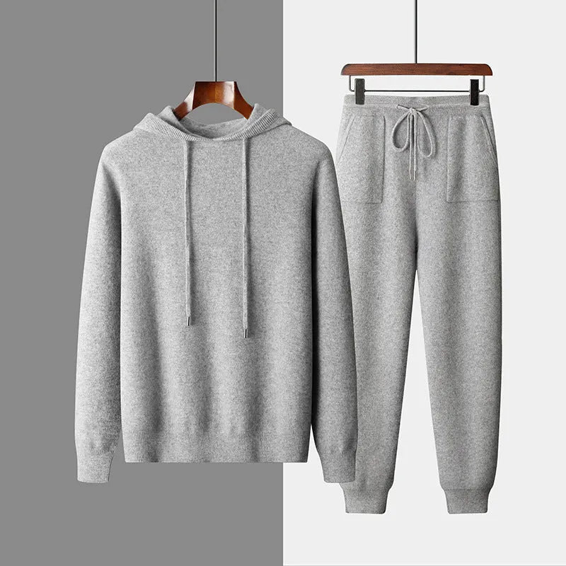 Men's light gray cashmere hoodie and matching trousers laid out as a complete casual two-piece set.