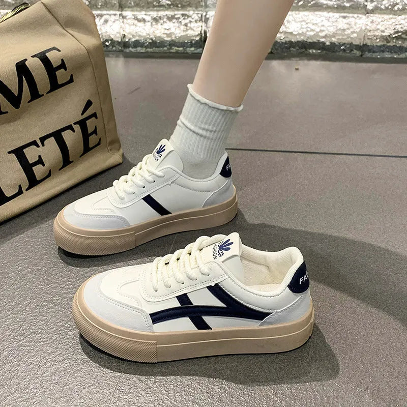 Brown and blue low-top casual lace-up shoes with a patent leather-look finish and flat rubber sole.