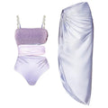 Purple one-piece swimsuit with matching wrap skirt on a mannequin, showing the tight fit and European/American styling.
