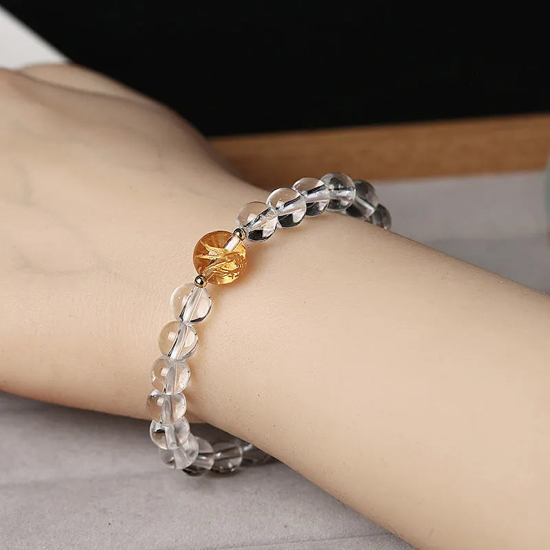 Geometric obsidian black agate and white crystal bracelet with golden dragon bead on adjustable cord.