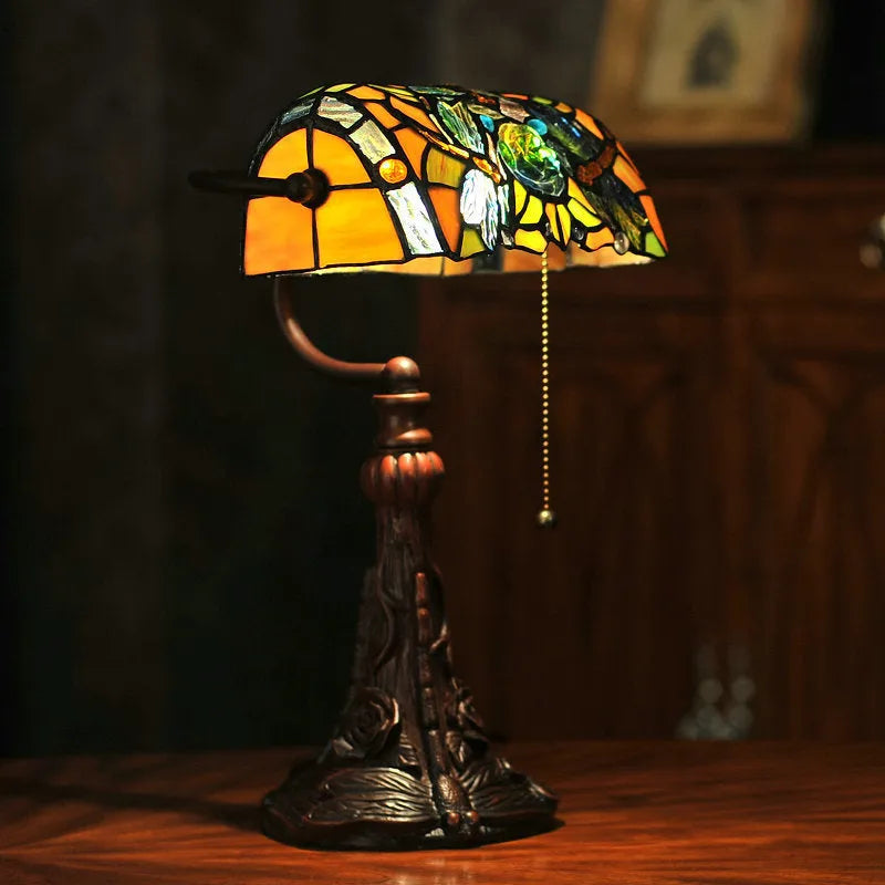 10-inch Tiffany stained glass table lamp with resin base on a desk.