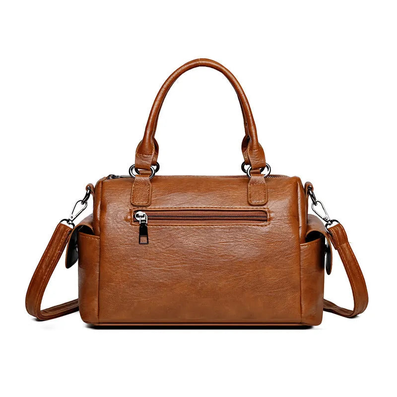 Vintage style large capacity square messenger bag in PU leather with contrast stitching.