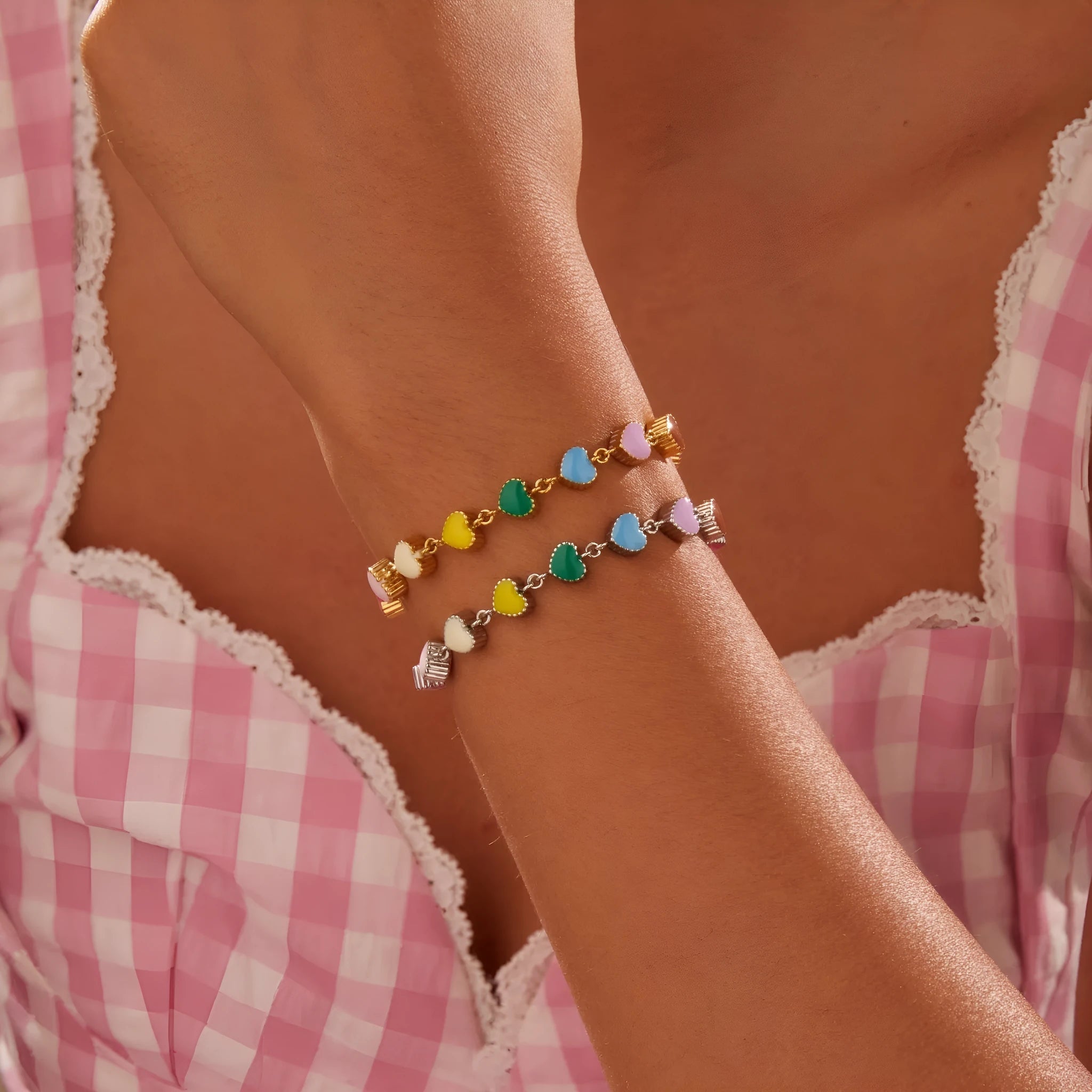 Close-up of a women's stainless steel bracelet with a colourful, heart-shaped titanium steel pendant.