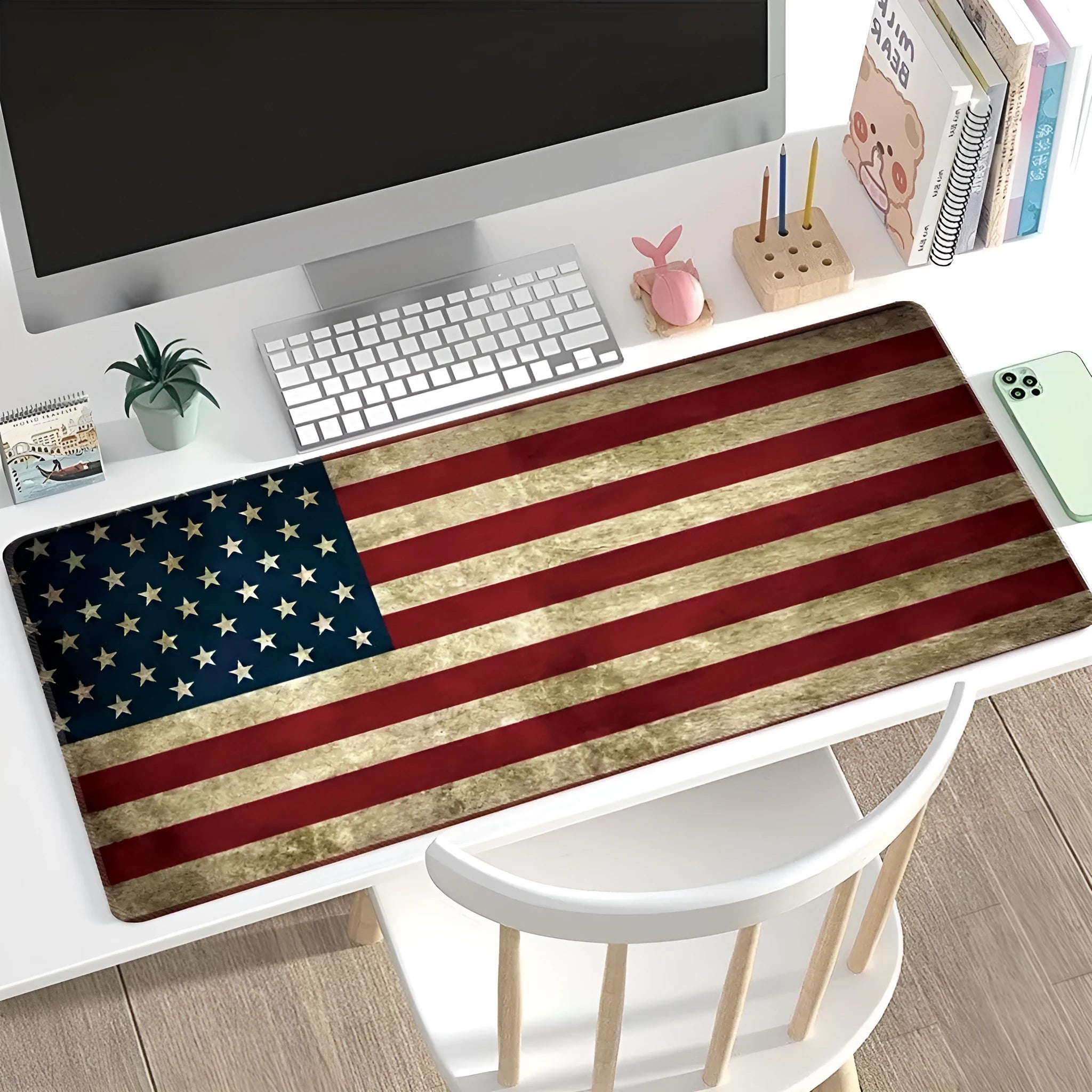 Large rectangular desk mouse pad with graphic pattern and natural rubber non-slip base on a wooden desk.