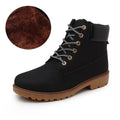 Pink high-top Martin boots with velvet lining, round toe, and front lace-up closure on a flat sole.