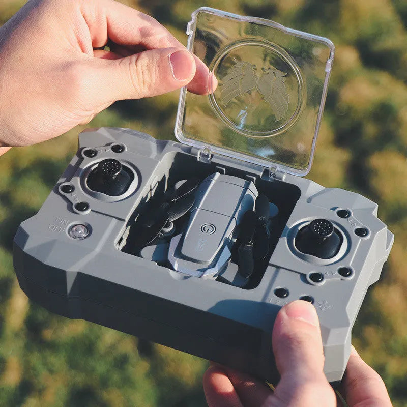 Mini four-axis drone with alloy body, folded size 6 x 7.5 x 3 cm, shown with remote control and protective rings