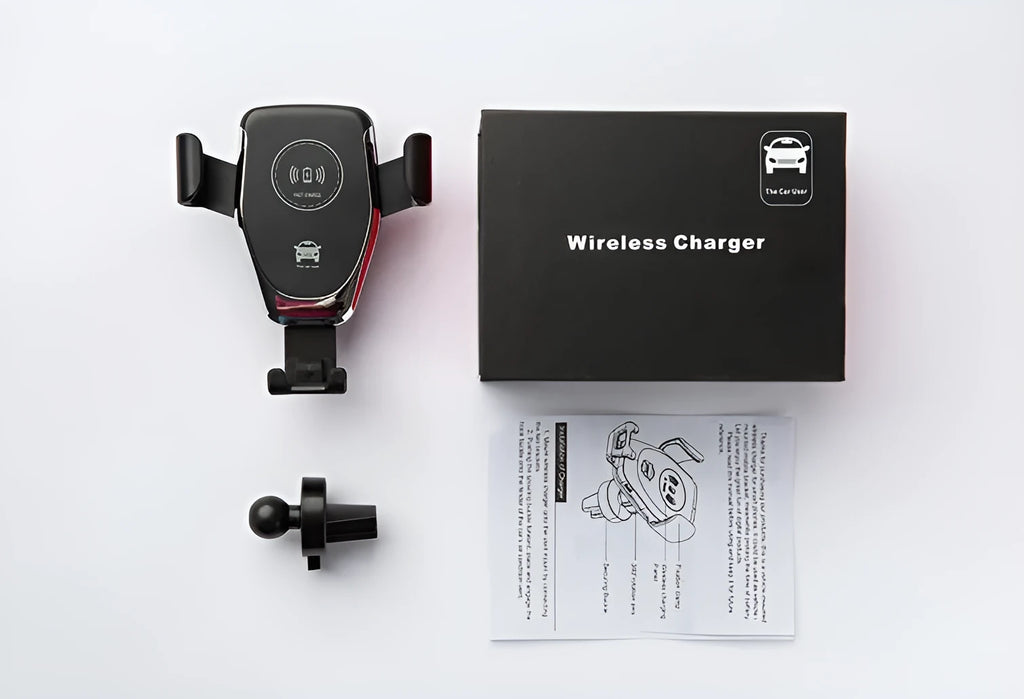 Black wireless car charger mounted on a car vent, holding an iPhone.
