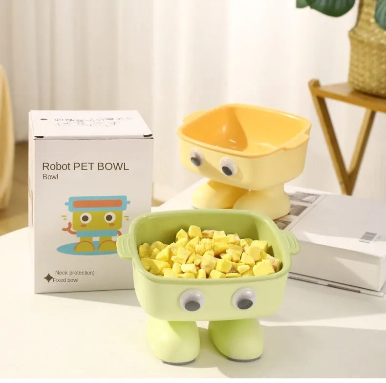 Green cartoon robot shaped elevated cat bowl with a tilted, detachable inner food dish.