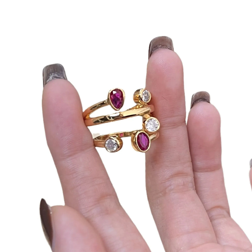 Copper double-headed ring with irregular cross geometric shape and diamond details in two-tone colours.