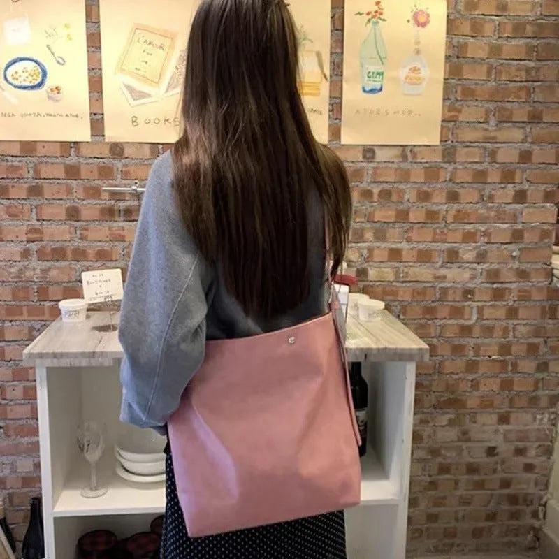 Corduroy one shoulder bag in pink or brown showing 39cm length and spacious interior for commuters