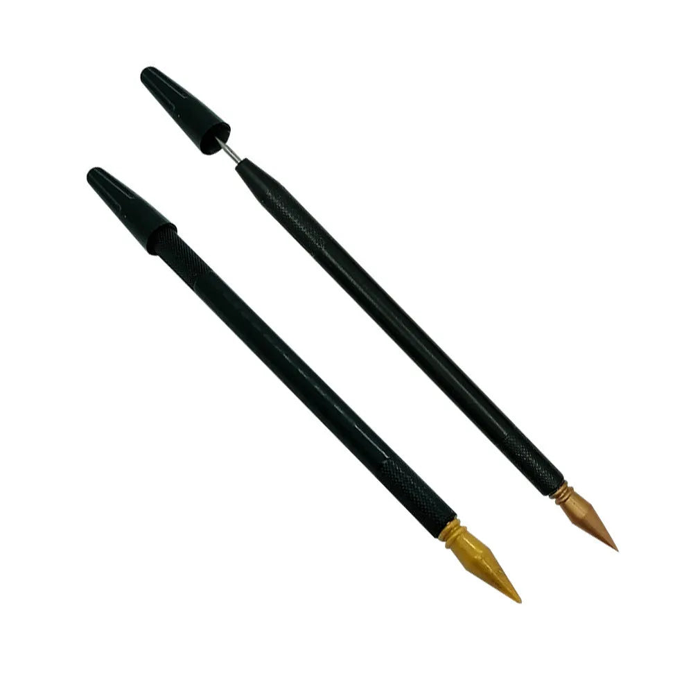 A white scratch art pen with a black brush tip on a wooden surface.