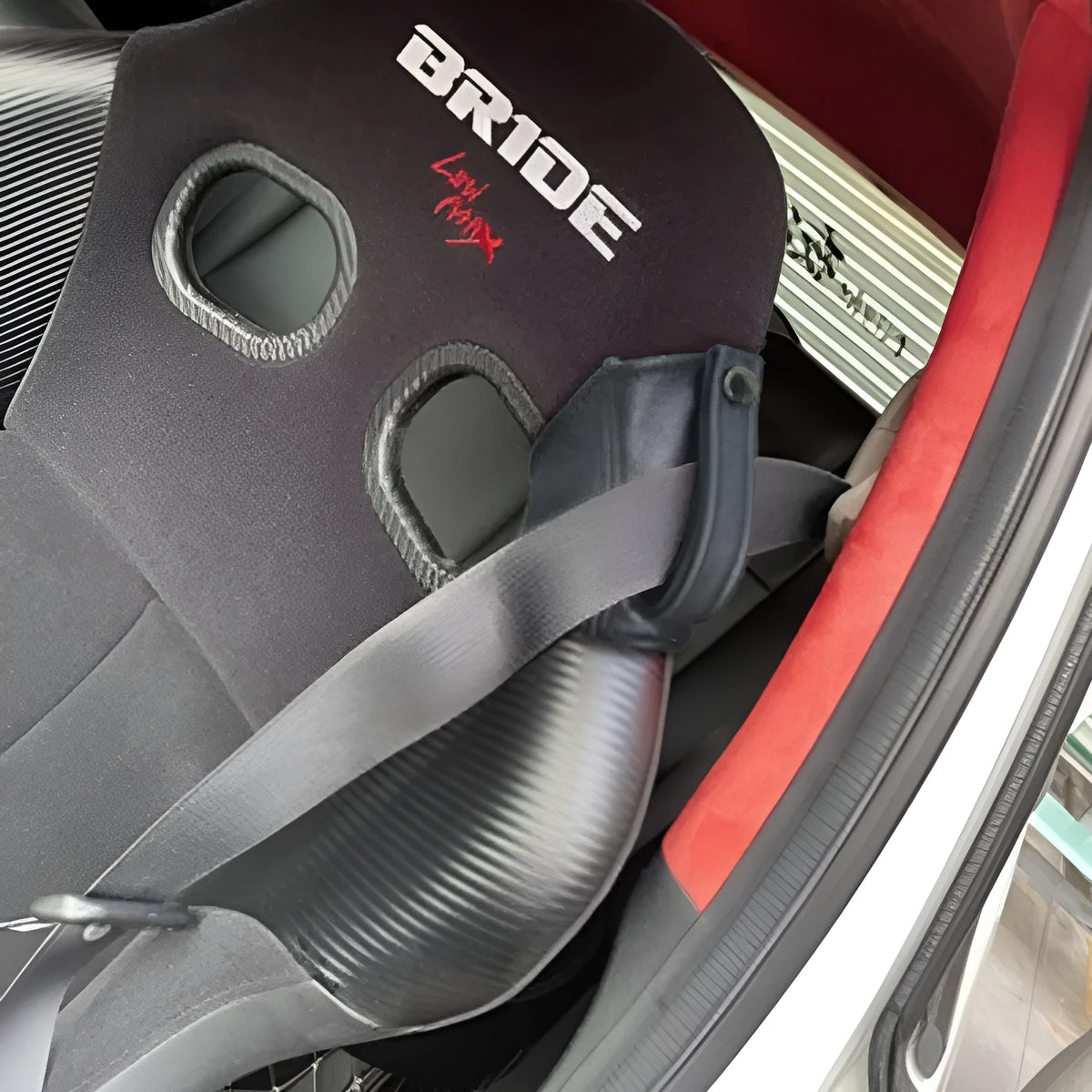Black leather racing seat belt buckle cover measuring 30cm by 20cm for RECARO and Bride harnesses.