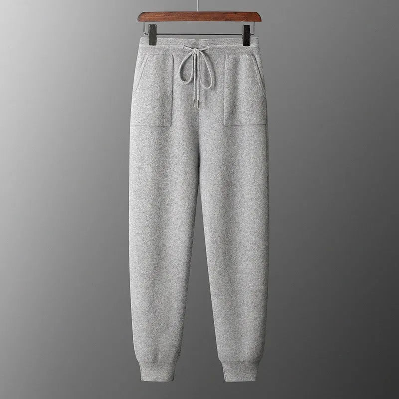 Men's light gray cashmere hoodie and matching trousers laid out as a complete casual two-piece set.