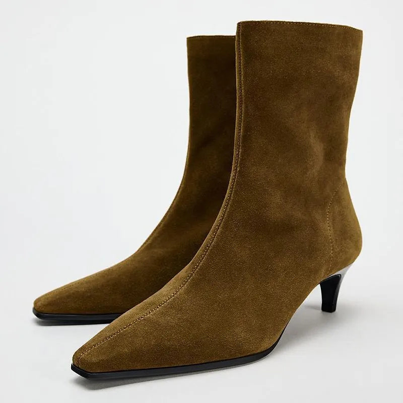 Brown square toe ankle boots with a side zip and a low kitten heel on a waterproof platform.