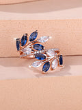 Copper leaf-shaped fashion ring with zircon details and an adjustable opening, shown in a rose gold finish.