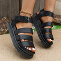 Black casual beach sandal with a thick rubber sole and a silver buckle strap on a PU upper.