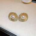 Vintage style earrings with simulated pearl drops in irregular flower shape design