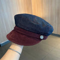 Dark blue denim newsboy hat with octagonal crown and contrasting brim