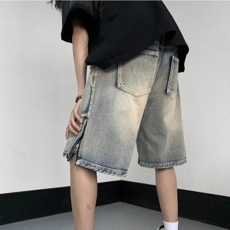 Blue retro-style tattered denim shorts with a wide leg loose fit on a hanger.