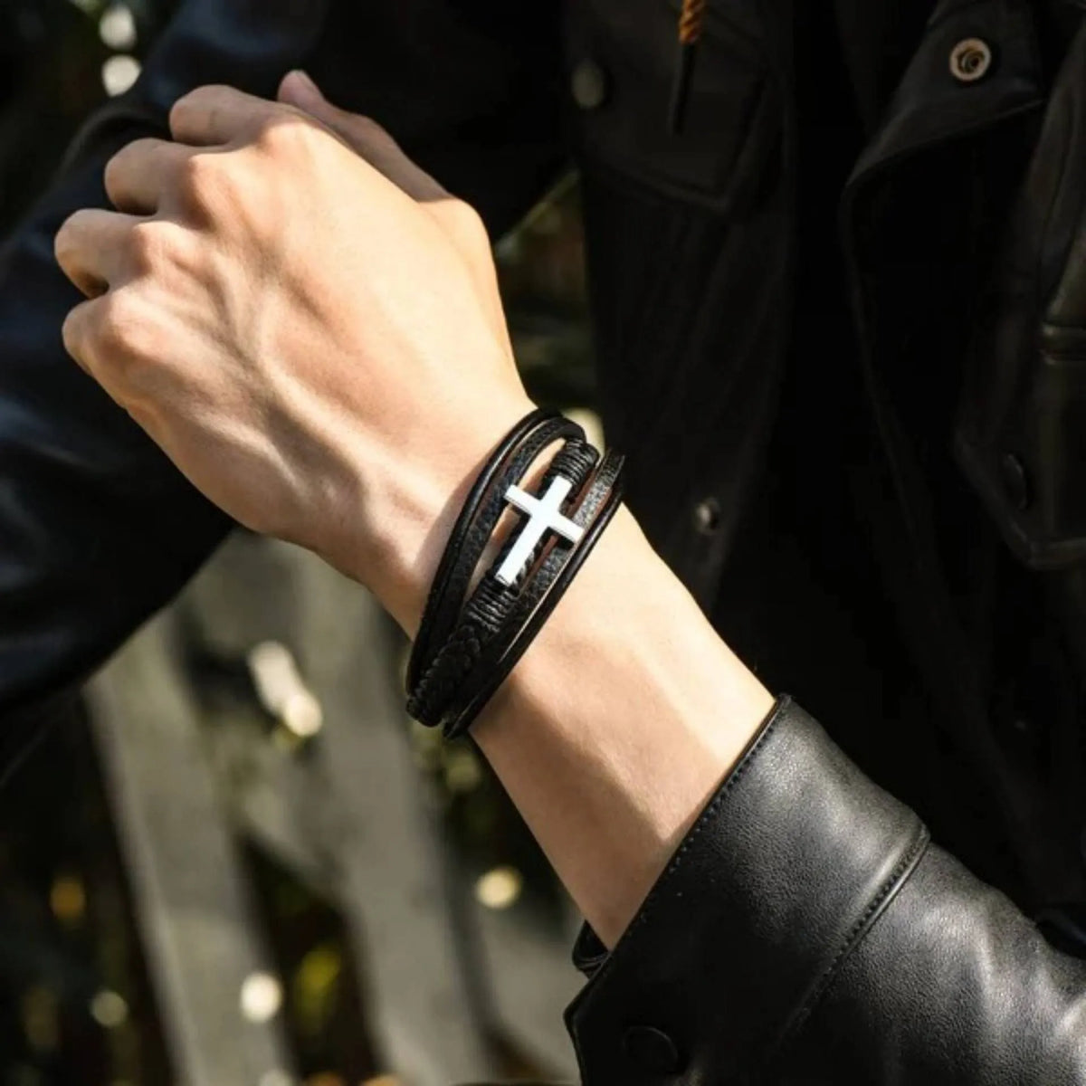 Men's stainless steel cross bracelet with leather band and plated finish, shown in steel and black colour options