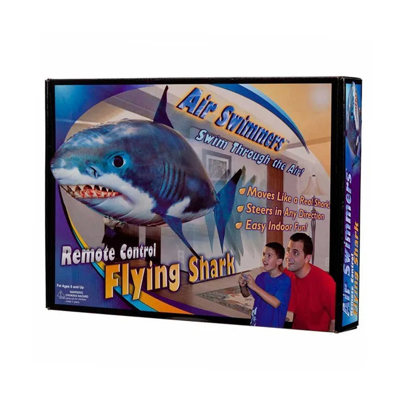Large remote control inflatable shark balloon toy floating indoors with remote controller.