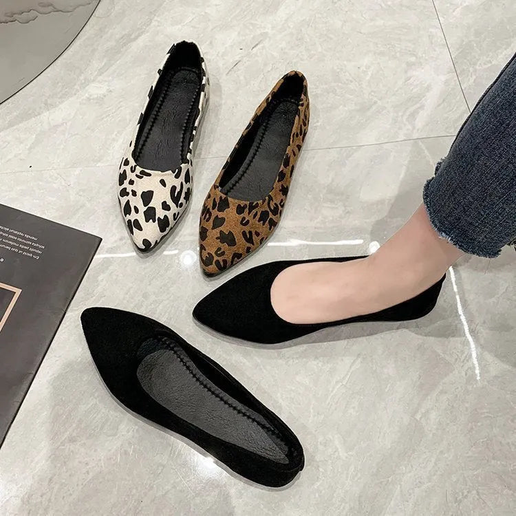 Women's leopard print flat pumps with pointed toe and low heel on a cotton cloth upper.