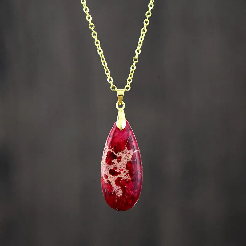 Emperor stone jade water drop pendant necklace with 18K gold plated chain on display.