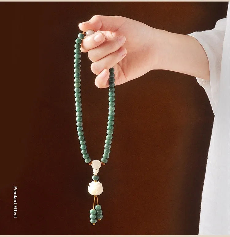 Bodhi seed beaded bracelet with a double ring safety buckle clasp featuring a Lotus detail.