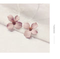 A pair of floral-shaped stud earrings for women, shown in alloy with an electroplated finish in white or pink colour.