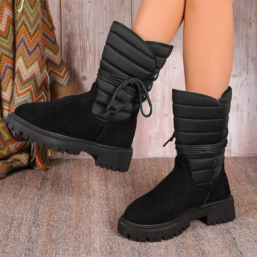 Women's black suede chunky heel snow boots with fleece lining and lace-up design.
