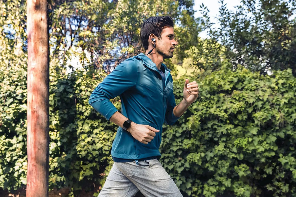 Black smart watch with silicone strap showing 1.4-inch touchscreen displaying heart rate data.