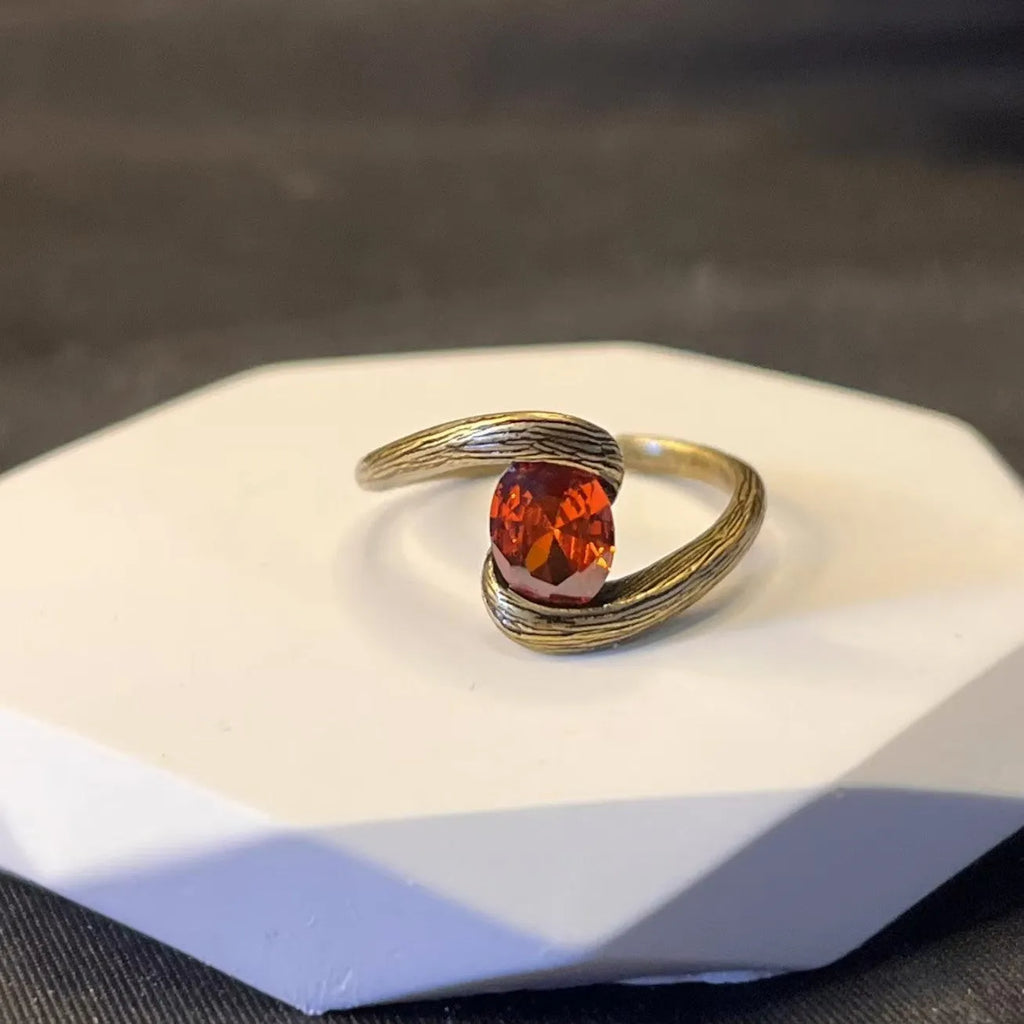 Copper adjustable ring with brushed finish and diamond coloured gem in retro heart shape