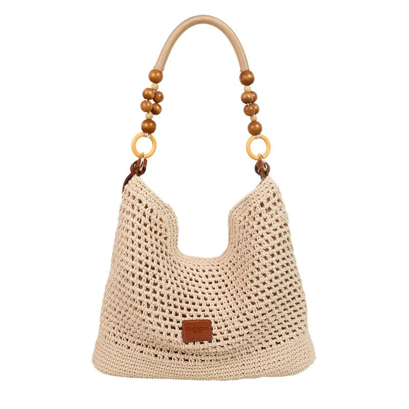 Knitted tote beach bag showing bucket shape, contrast stitching, and crossbody strap