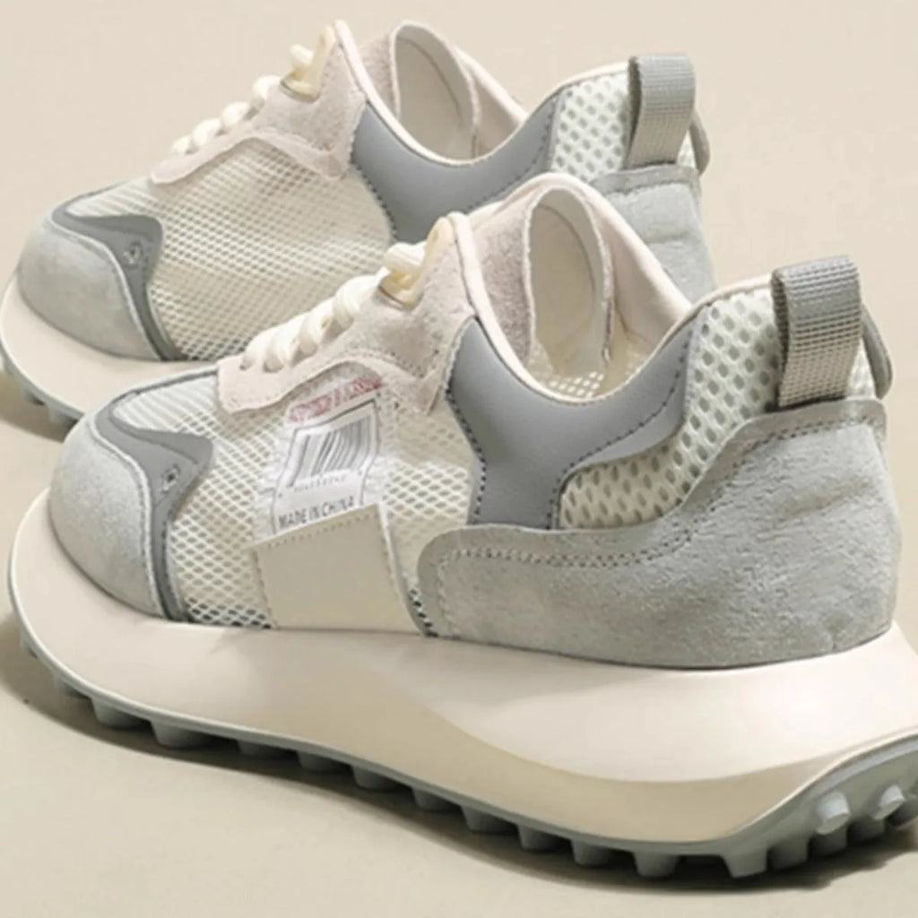 Women's gray retro sneaker with mesh lining and rubber sole on wooden floor