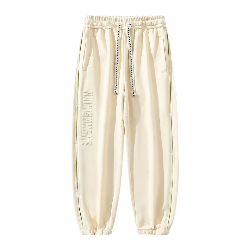 Men's loose-fit cotton trousers with stitching print design and ankle band in grey green.