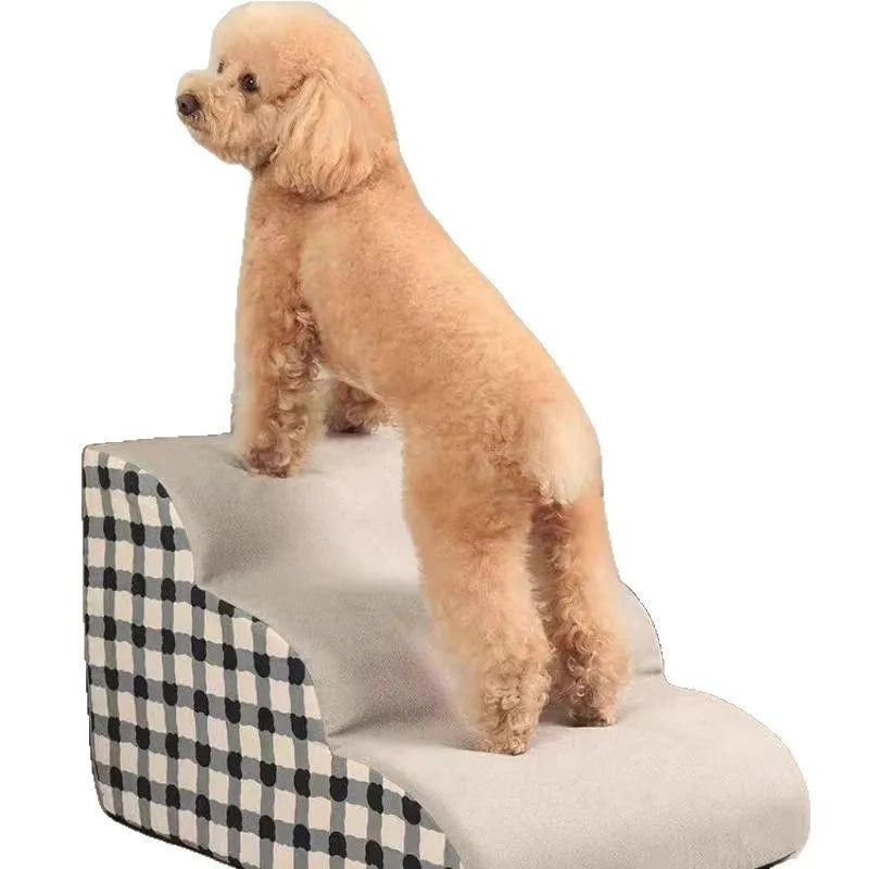 Wooden pet climbing ladder with fabric steps in orange bear plaid pattern beside a bed