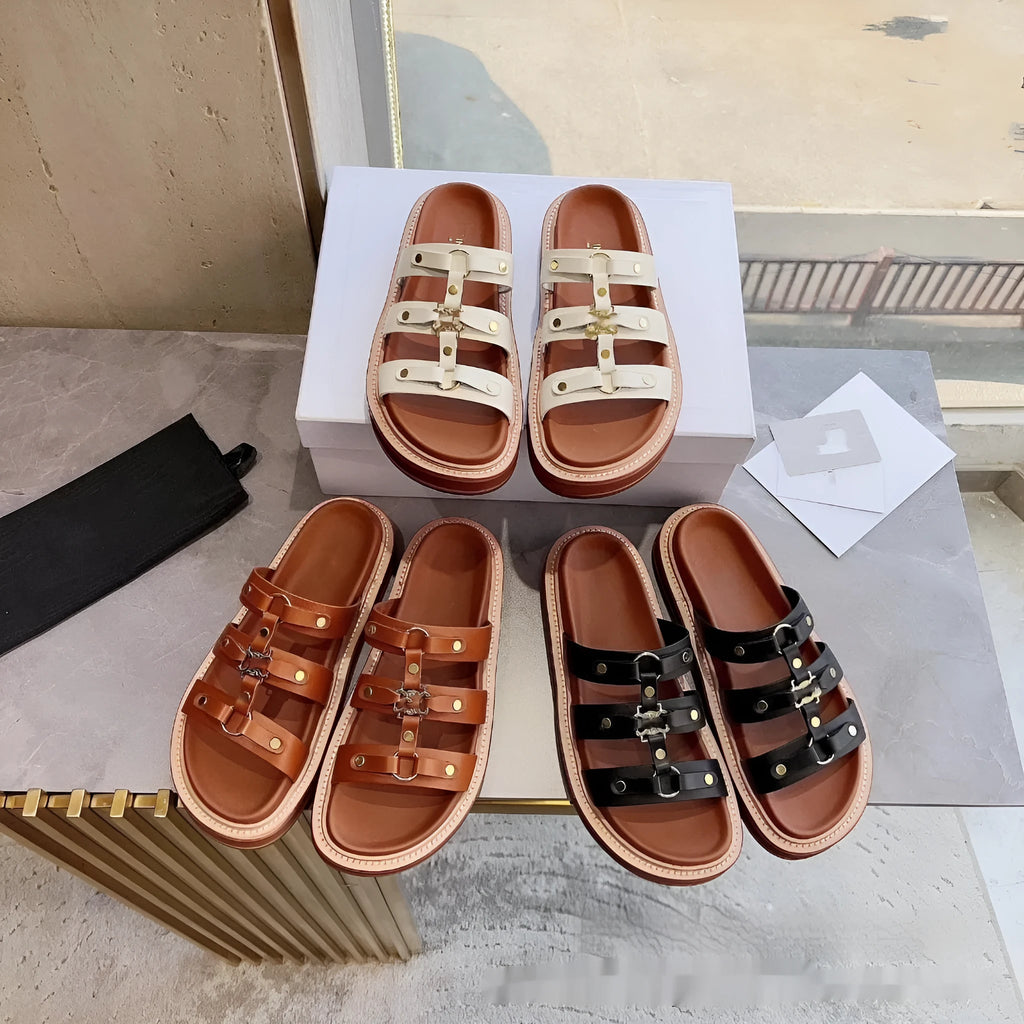 Women's white patent leather Roman style sandal slippers with sheepskin upper on a neutral background.