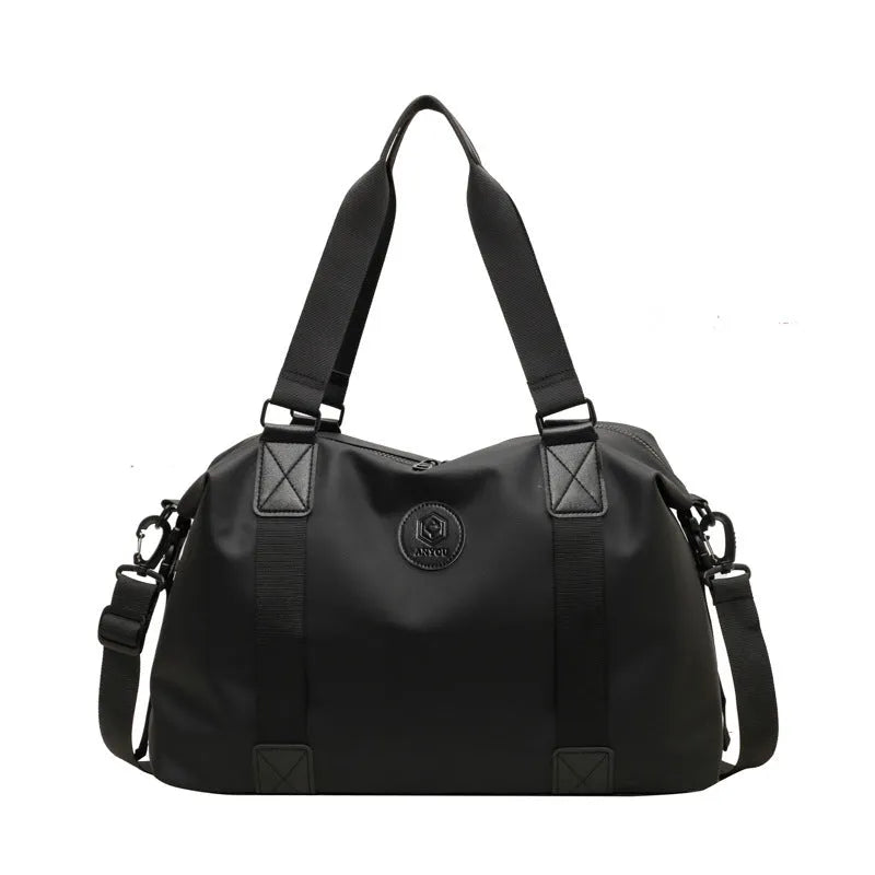 Large black waterproof Oxford cloth travel backpack with multiple compartments shown on a grey background.
