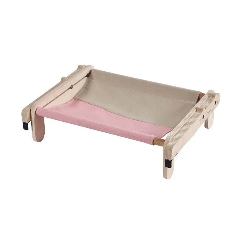 Solid wood pet bed for cats with removable washable cover in black and white plaid pattern on floor
