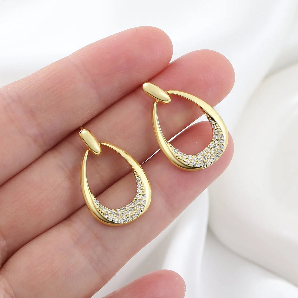 Yellow gold geometric drop-shaped women's earrings with round and oval design elements.