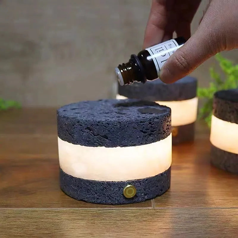 Small orange volcanic rock touch night lamp with USB port and essential oil reservoir.