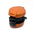 Bright red multifunction breakfast machine with sandwich press and egg cooker ring on baking tray