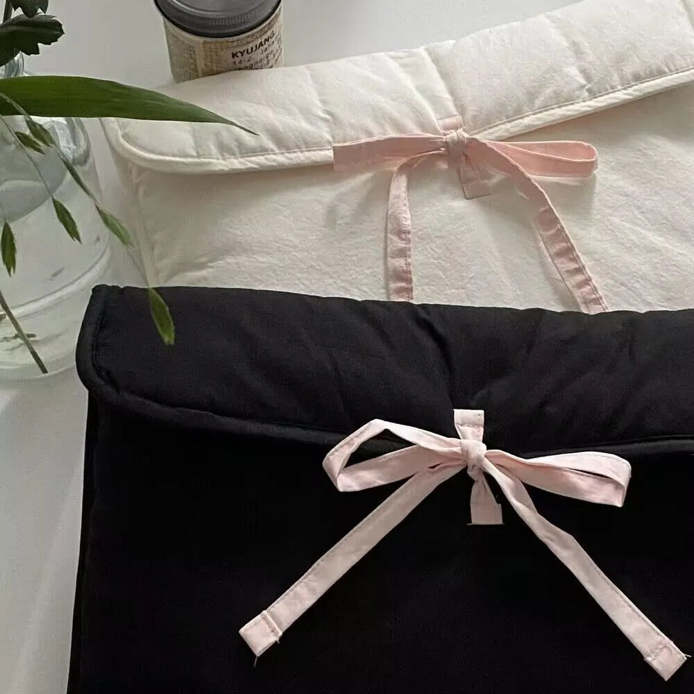 Women's black and white striped quilted computer bag with ballet style bow detail
