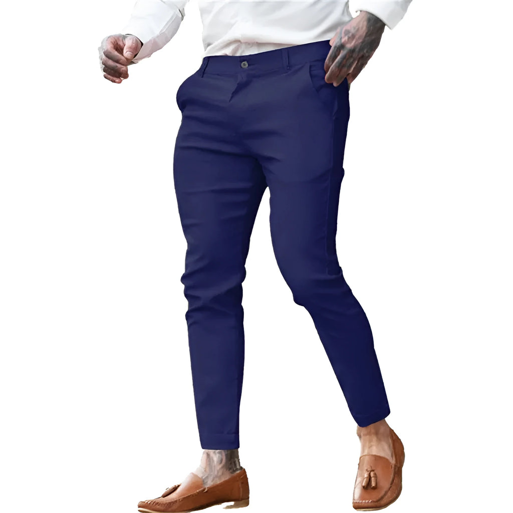Men's slim fit stretch cotton pencil pants in a solid colour on a model.