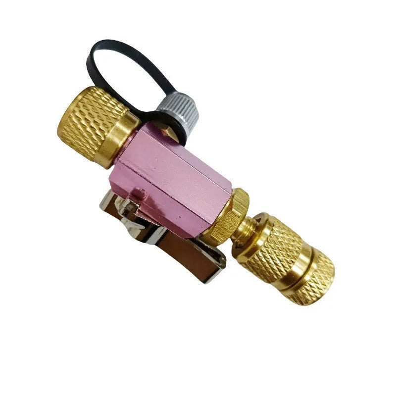 Metal valve core disassembly tool set showing black and pink valve removers with wrench attachment.