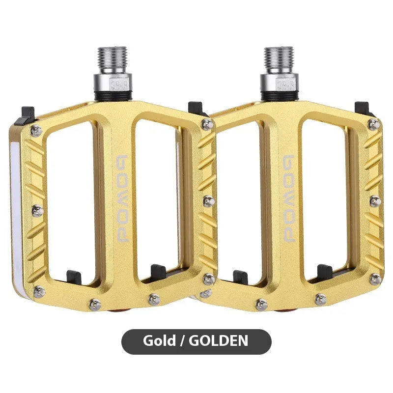 Aluminium alloy bicycle pedals with 710 LED lights in purple, black, titanium, red, and gold colours.