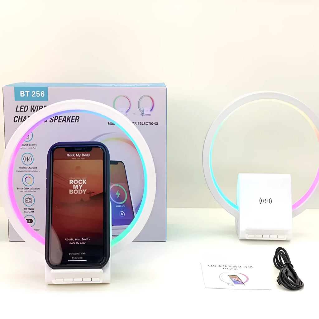 White portable Bluetooth speaker with integrated wireless charging pad and ambient lighting.