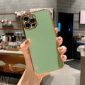 iPhone 13 Pro Max phone case with gold plated frame and pink silicone stripes on a white TPU background