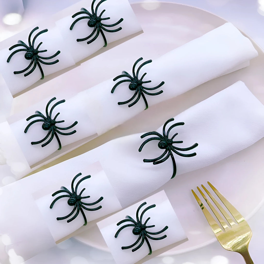 Six black alloy spider-shaped napkin rings for Halloween table decoration.